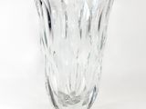 a glass vase that is sitting on a white surface