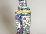 a vase that is sitting on a stand on a table