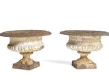 two vases sitting next to each other on a white surface
