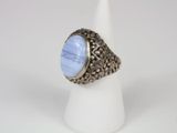 a close up of a ring with a blue stone on it