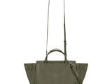 the small leather tote bag is green and has a long strap