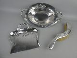 a silver plate with a spoon and a brush