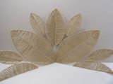 a wicker sculpture of a leaf on a white surface