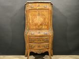 an old wooden cabinet with a drawer on top of it