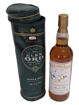 an image of a bottle of whisky next to a black box