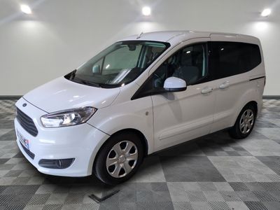 la camionnette blanche est garée sur le sol en damier d'un garage