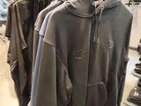 clothing hanging on a rack in a clothing store in a store