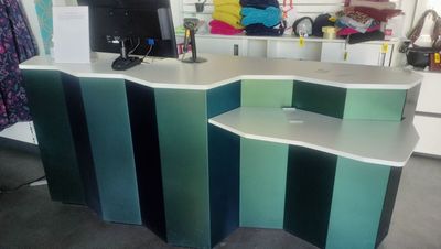 a desk with a computer on top of it in a room