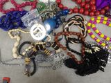 a pile of assorted necklaces and bracelets on a table