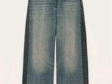 the jeans are blue and have a black stripe on the side