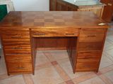 a wooden desk with a checkered top in a room