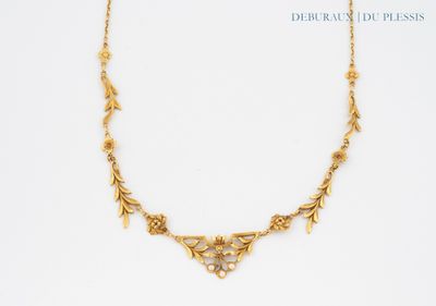 a close up of a gold necklace on a white background