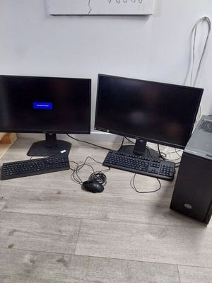 deux écrans d'ordinateur et un clavier posés par terre