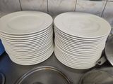many plates stacked on top of each other on the kitchen counter