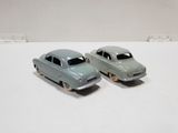 two toy cars that are sitting on a table