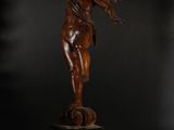 a bronze statue of an angel on a pedestal