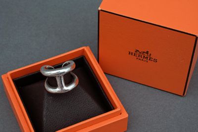 an orange box with a silver ring inside of it on a table