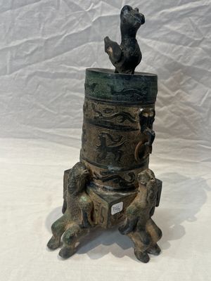a statue of a bird sitting on top of a tree stump