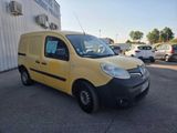 the small yellow van is parked in the parking lot