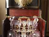 a black and gold case with a lot of wine glasses