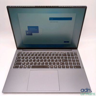 an open laptop computer sitting on top of a white table