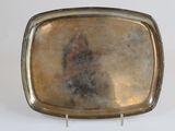 a silver plate with a picture of a woman on it
