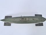 a metal model of a submarine on a white surface