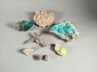 some rocks and a cross on a table with a white background