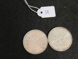 two coins that are next to each other on a table