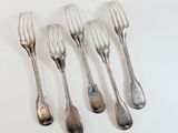 four forks are lined up on a white surface with silverware on them