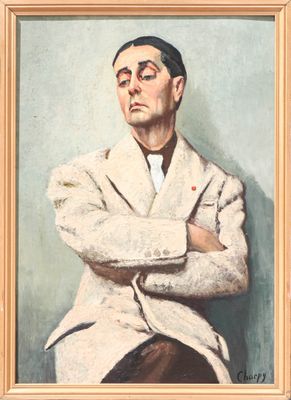 portrait of a man in a white coat with his arms crossed