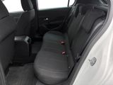 the back seats of a white car with a black seat belt