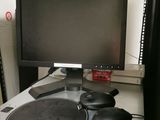 a computer monitor sitting on top of a desk next to a mouse