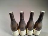 three bottles of wine sitting next to each other on a table