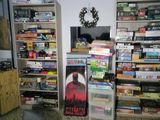 a refrigerator in the corner of a room with a lot of shelves