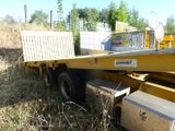 a truck that is sitting in the grass with a box on the back of it