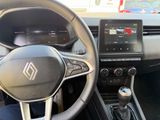 the interior of a car with a steering wheel, dashboard, and dashboard controls
