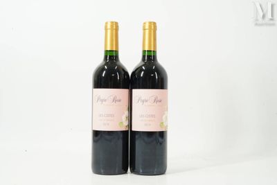 two bottles of wine sitting next to each other on a table