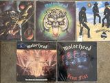 four cd ' s of motorhead on display on the floor
