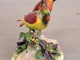a figurine of two birds sitting on top of a rock
