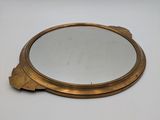 a close up of a mirror on a table with a white background