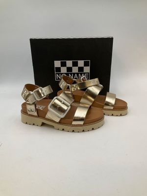 a close up of a pair of sandals on a white surface