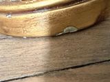 a close up of a wooden table with a bowl on top of it