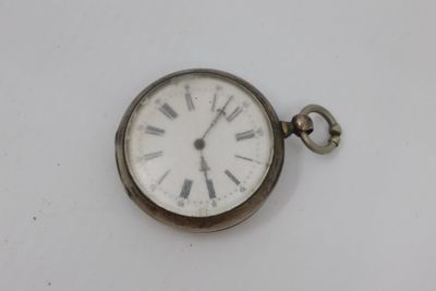 a silver pocket watch with roman numerals on the face