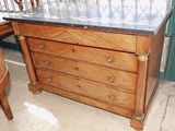 a wooden chest of drawers with a marble top