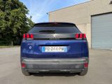 the rear end of a blue suv parked in a parking lot