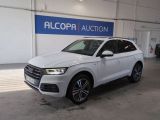 a white audi suv parked inside of a building