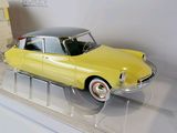 a yellow toy car with a trailer attached to it