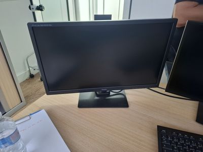 a computer monitor sitting on top of a desk next to a keyboard and mouse