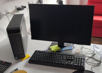 un bureau d'ordinateur équipé d'un écran, d'un clavier, d'une souris et d'un tapis de souris